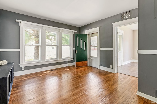 1114 W Monroe St, Kokomo, IN 46901 - unfurnished living room featuring hardwood / wood-style floors and baseboards