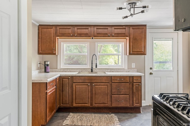 1114 W Monroe St, Kokomo, IN 46901 - kitchen featuring healthy amount of natural light, light countertops, brown cabinetry, and crown molding