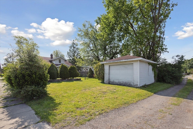 317 N Sunnyside Ave, South Bend, IN 46617 - view of green lawn featuring a detached garage, an outbuilding, and driveway
