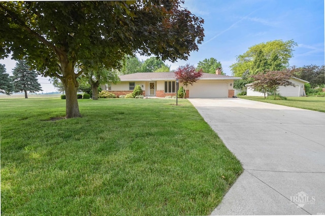 3209 E Kendall Ln, Muncie, IN 47303 - ranch-style house featuring an attached garage, driveway, a chimney, and a front yard