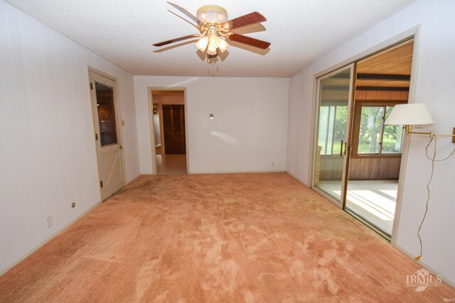 3209 E Kendall Ln, Muncie, IN 47303 - unfurnished room with carpet floors, ceiling fan, and wooden walls