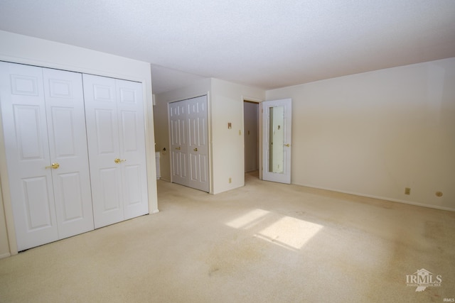 3209 E Kendall Ln, Muncie, IN 47303 - unfurnished bedroom with carpet and two closets