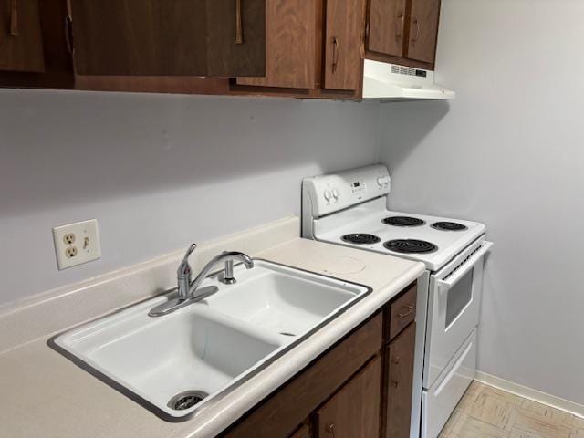 2500 Topsfield Rd Unit 907, South Bend, IN 46614 - kitchen with white electric range, under cabinet range hood, light countertops, and dark brown cabinets