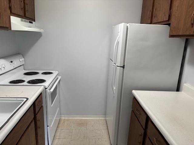 2500 Topsfield Rd Unit 907, South Bend, IN 46614 - kitchen featuring white appliances, under cabinet range hood, light countertops, and light flooring