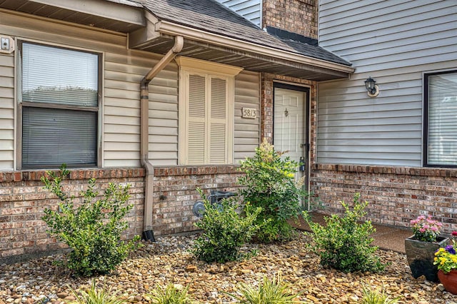 5813 Polo Run, Evansville, IN 47715 - property entrance with a shingled roof and brick siding