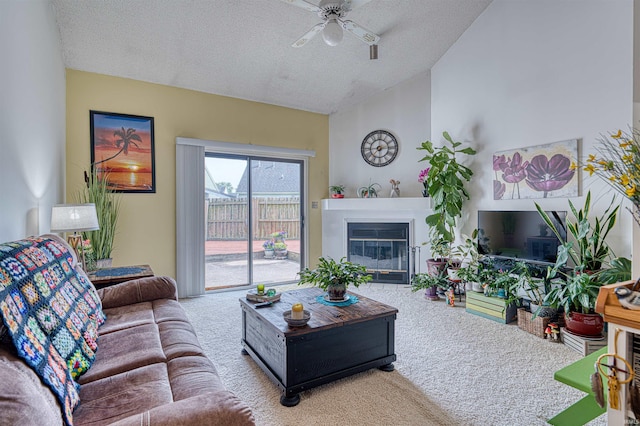 5813 Polo Run, Evansville, IN 47715 - living room with carpet floors, a ceiling fan, a textured ceiling, a glass covered fireplace, and vaulted ceiling