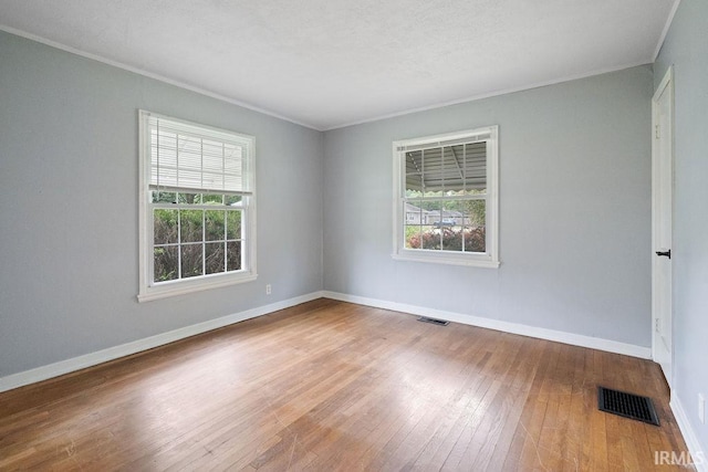 2222 S Indiana Ave, Kokomo, IN 46902 - spare room with healthy amount of natural light, hardwood / wood-style flooring, and crown molding