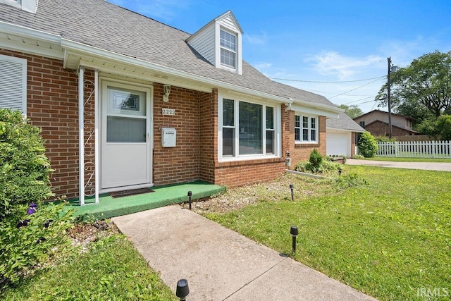 2222 S Indiana Ave, Kokomo, IN 46902 - doorway to property with brick siding, a garage, and a shingled roof