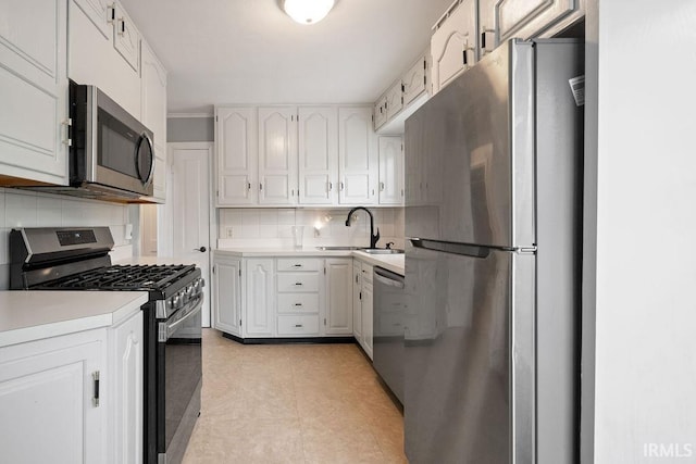 2222 S Indiana Ave, Kokomo, IN 46902 - kitchen with appliances with stainless steel finishes, backsplash, light countertops, and white cabinets