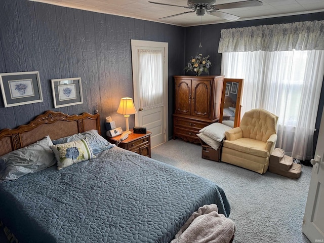306 W Rochester St, Akron, IN 46910 - bedroom with carpet flooring, multiple windows, ceiling fan, and wooden walls