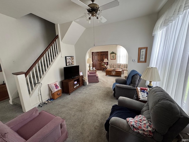 306 W Rochester St, Akron, IN 46910 - living area featuring arched walkways, carpet flooring, ceiling fan, stairway, and vaulted ceiling