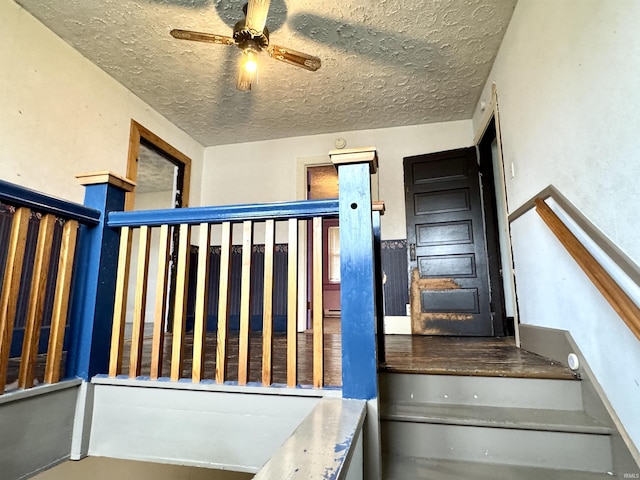 203 E Church St, Milroy, IN 46156 - staircase featuring a textured ceiling and ceiling fan