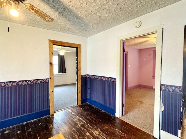 203 E Church St, Milroy, IN 46156 - empty room with ceiling fan, a textured ceiling, hardwood / wood-style floors, a smoke detector, and carpet