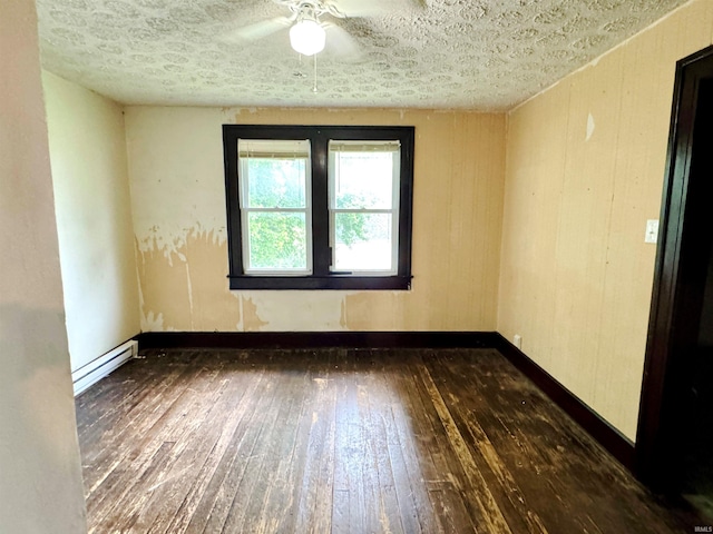 203 E Church St, Milroy, IN 46156 - spare room with hardwood / wood-style flooring, a ceiling fan, a baseboard radiator, and a textured ceiling