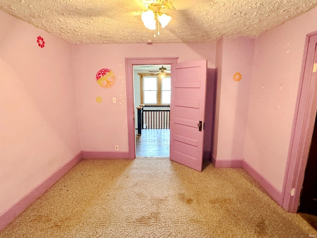 203 E Church St, Milroy, IN 46156 - spare room with a ceiling fan, light carpet, and a textured ceiling