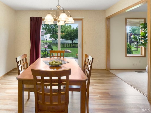 2133 Blue Harbor Dr, Fort Wayne, IN 46804 - dining room featuring a chandelier and wood finished floors