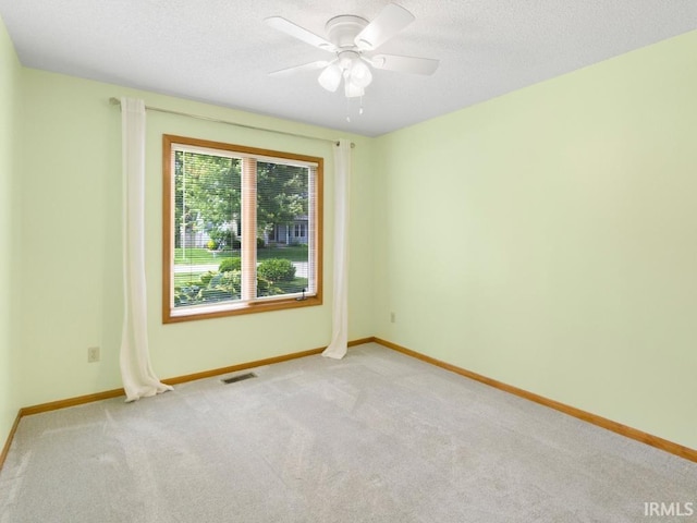 2133 Blue Harbor Dr, Fort Wayne, IN 46804 - empty room featuring light colored carpet, ceiling fan, and a textured ceiling