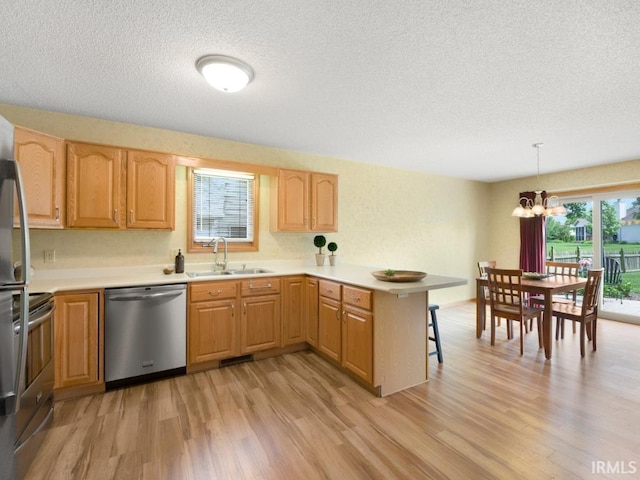 2133 Blue Harbor Dr, Fort Wayne, IN 46804 - kitchen featuring appliances with stainless steel finishes, a peninsula, light wood-type flooring, a chandelier, and a kitchen bar