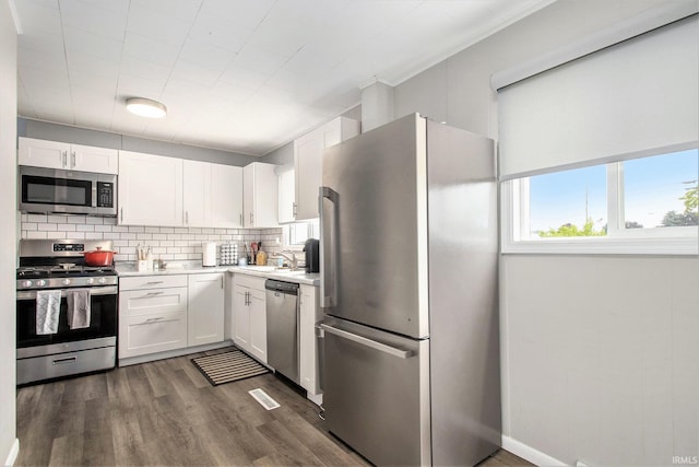 2734 Hawthorne St, Elkhart, IN 46517 - kitchen with appliances with stainless steel finishes, white cabinetry, light countertops, and tasteful backsplash