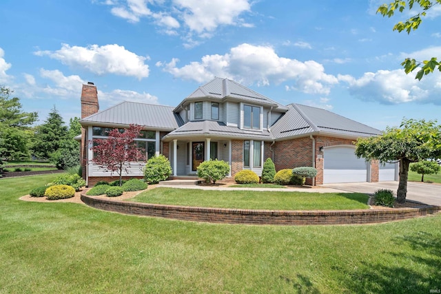 4416 Lakeshore Dr, Kokomo, IN 46902 - traditional-style house featuring a chimney, brick siding, driveway, a garage, and a front lawn