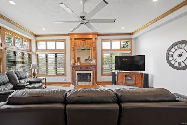 4416 Lakeshore Dr, Kokomo, IN 46902 - living area featuring ornamental molding, healthy amount of natural light, a high end fireplace, a ceiling fan, and a textured ceiling