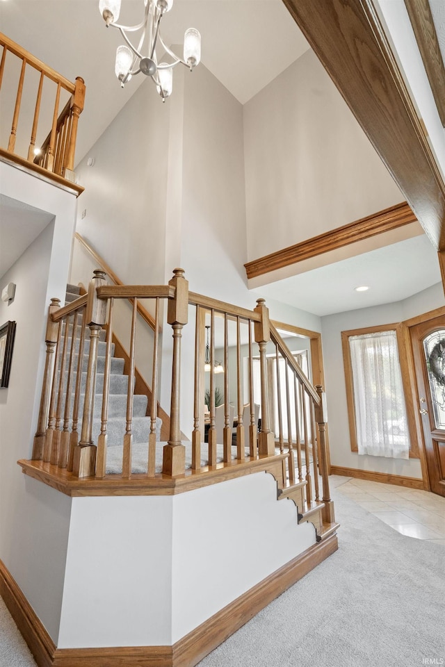 4416 Lakeshore Dr, Kokomo, IN 46902 - stairway with high vaulted ceiling, carpet flooring, and a chandelier