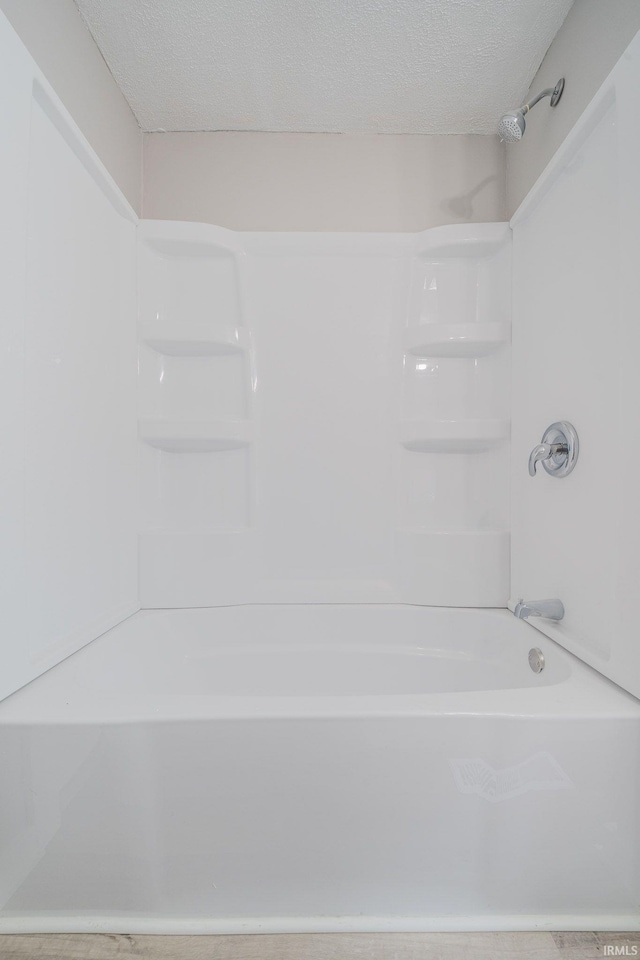 921 Race St, Logansport, IN 46947 - full bathroom featuring bathtub / shower combination and a textured ceiling