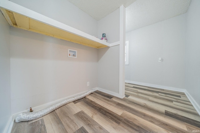 921 Race St, Logansport, IN 46947 - laundry room featuring washer hookup, wood finished floors, and a textured ceiling