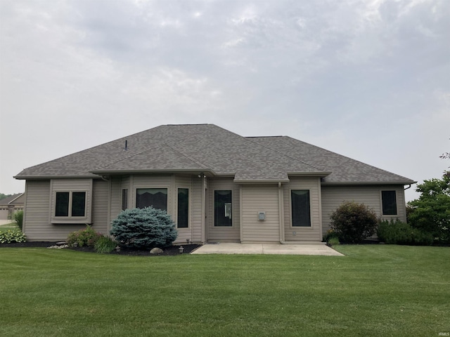 1526 Treyburn Ct, Bluffton, IN 46714 - rear view of house featuring a patio area, a yard, and a shingled roof
