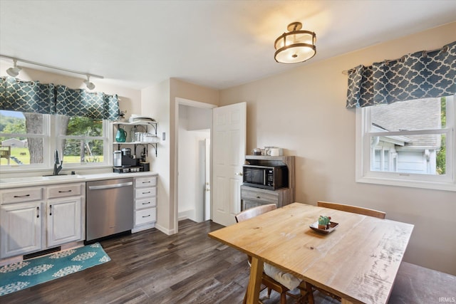 439E 17th St, Mishawaka, IN 46544 - kitchen with dishwasher, dark wood-type flooring, black microwave, light countertops, and rail lighting
