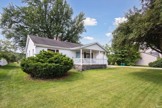 439E 17th St, Mishawaka, IN 46544 - single story home with a porch, a chimney, a front lawn, and roof with shingles