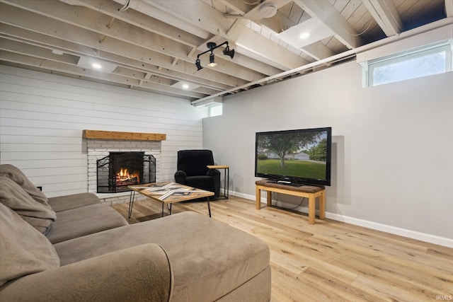 439E 17th St, Mishawaka, IN 46544 - living room featuring wood finished floors, beamed ceiling, and a fireplace