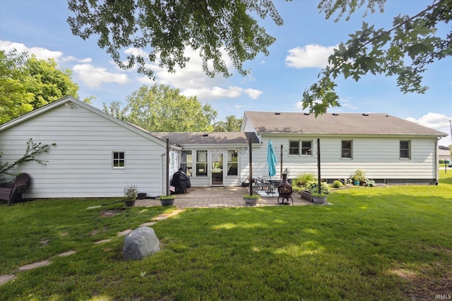 439E 17th St, Mishawaka, IN 46544 - back of house featuring a patio, a yard, and a shingled roof