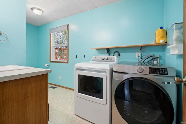 3076 N 450 Rd E, Logansport, IN 46947 - laundry room with separate washer and dryer and a textured ceiling