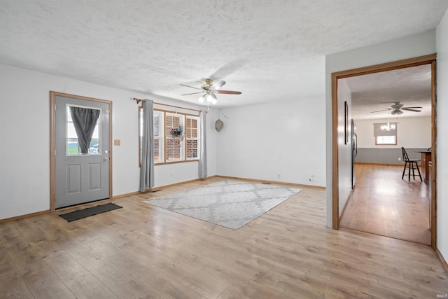 3076 N 450 Rd E, Logansport, IN 46947 - foyer entrance with ceiling fan, a textured ceiling, and light wood finished floors
