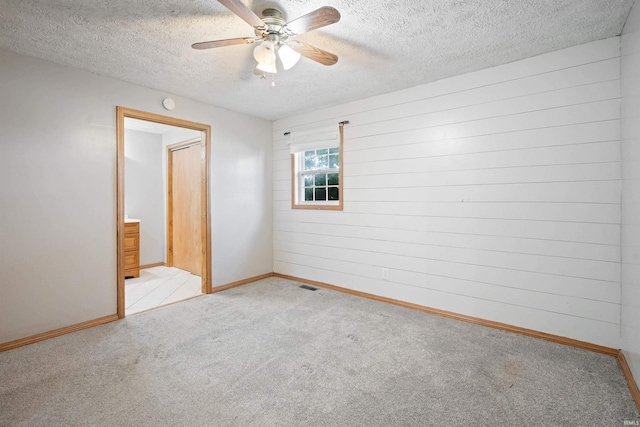 3076 N 450 Rd E, Logansport, IN 46947 - empty room with carpet floors, a ceiling fan, and a textured ceiling