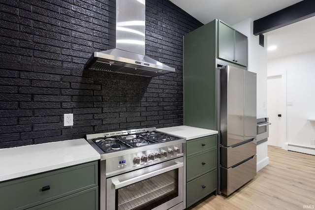 5228 N Lee Ct, South Bend, IN 46614 - kitchen featuring green cabinetry, wall chimney exhaust hood, stainless steel appliances, and light countertops