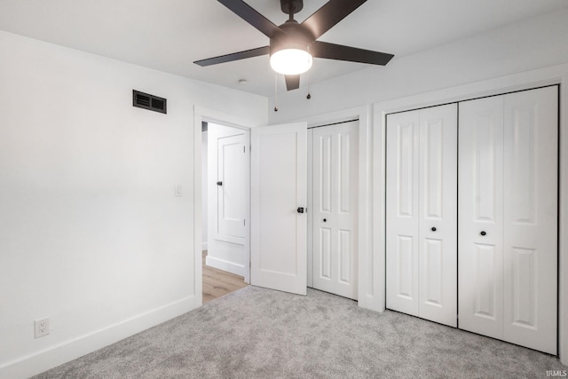 5228 N Lee Ct, South Bend, IN 46614 - unfurnished bedroom featuring light carpet, multiple closets, and ceiling fan