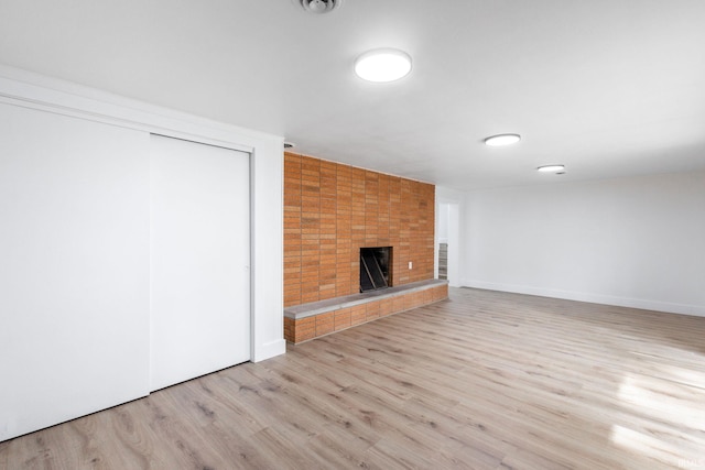 5228 N Lee Ct, South Bend, IN 46614 - unfurnished living room featuring wood finished floors and a fireplace