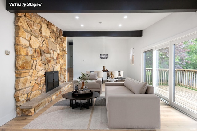 5228 N Lee Ct, South Bend, IN 46614 - living room featuring beamed ceiling, light wood-style floors, a stone fireplace, and recessed lighting