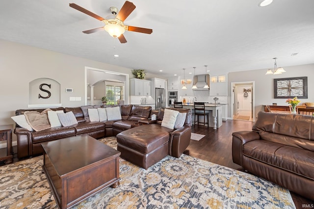 1869 Paloma Ct, Lafayette, IN 47909 - living room featuring dark wood-style floors, ceiling fan, arched walkways, a chandelier, and recessed lighting