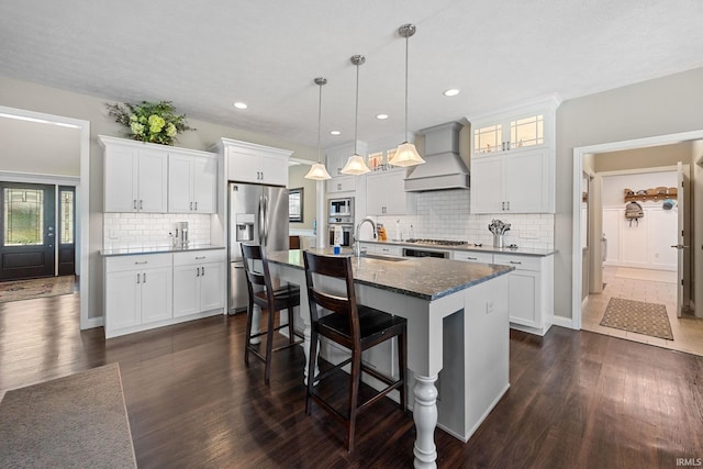 1869 Paloma Ct, Lafayette, IN 47909 - kitchen featuring custom exhaust hood, appliances with stainless steel finishes, dark wood-style flooring, a breakfast bar area, and recessed lighting
