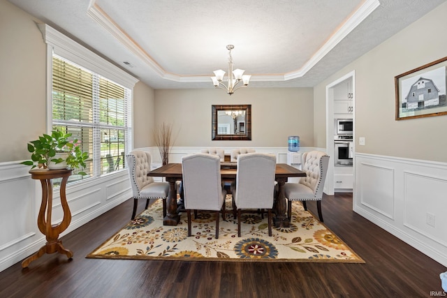 1869 Paloma Ct, Lafayette, IN 47909 - dining space featuring a tray ceiling, a chandelier, a wainscoted wall, wood finished floors, and a decorative wall