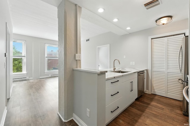 112 W Washington Blvd Unit 329, Fort Wayne, IN 46802 - kitchen featuring stainless steel appliances, a baseboard heating unit, a peninsula, dark wood-style flooring, and recessed lighting