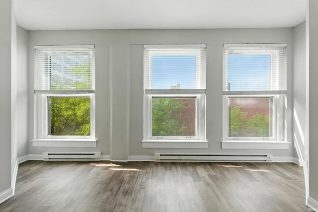 112 W Washington Blvd Unit 329, Fort Wayne, IN 46802 - spare room with a baseboard heating unit, wood finished floors, and plenty of natural light