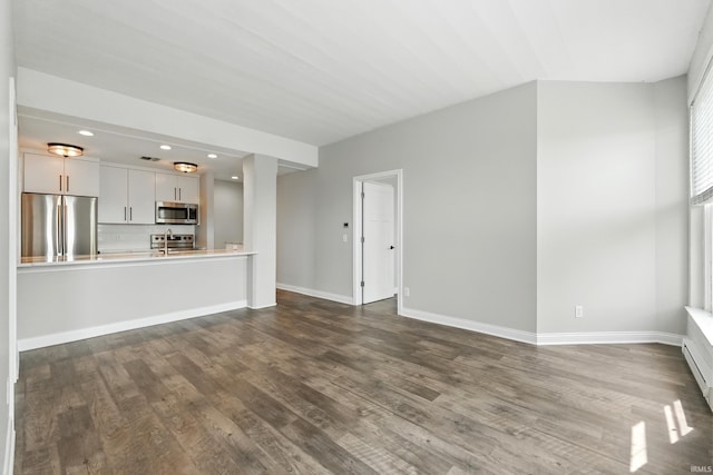 112 W Washington Blvd Unit 329, Fort Wayne, IN 46802 - unfurnished living room featuring dark wood-type flooring and recessed lighting