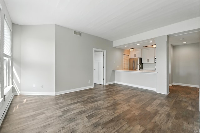 112 W Washington Blvd Unit 329, Fort Wayne, IN 46802 - unfurnished living room featuring dark wood-style flooring, recessed lighting, and a baseboard heating unit
