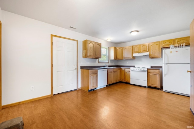 3610 E Sherwood Ter, Fort Wayne, IN 46806 - kitchen with white appliances, under cabinet range hood, light wood-style floors, and dark countertops