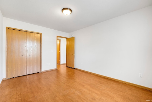 3610 E Sherwood Ter, Fort Wayne, IN 46806 - unfurnished bedroom featuring light wood-style flooring and a closet
