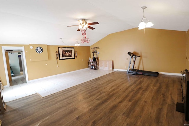 2907 Prairie Ln, Lafayette, IN 47904 - unfurnished living room with a ceiling fan, wood finished floors, vaulted ceiling, and a chandelier